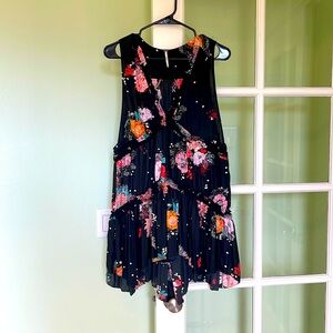 Free People black sleeveless ruffled A-line mini dress.